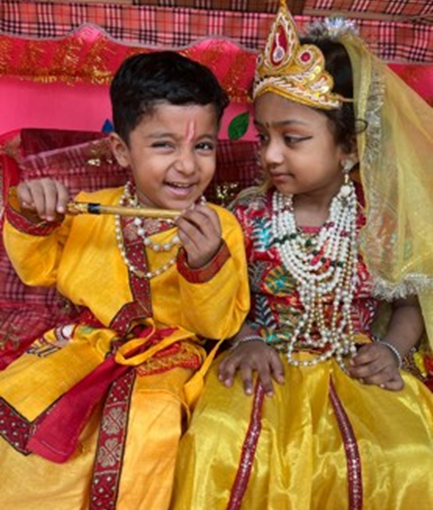 Boy dressed as Lord Krishna and girl dressed as Radha during Janmashtami Celebration at Udayan Kidz Premium Preschool and Day Care Center.